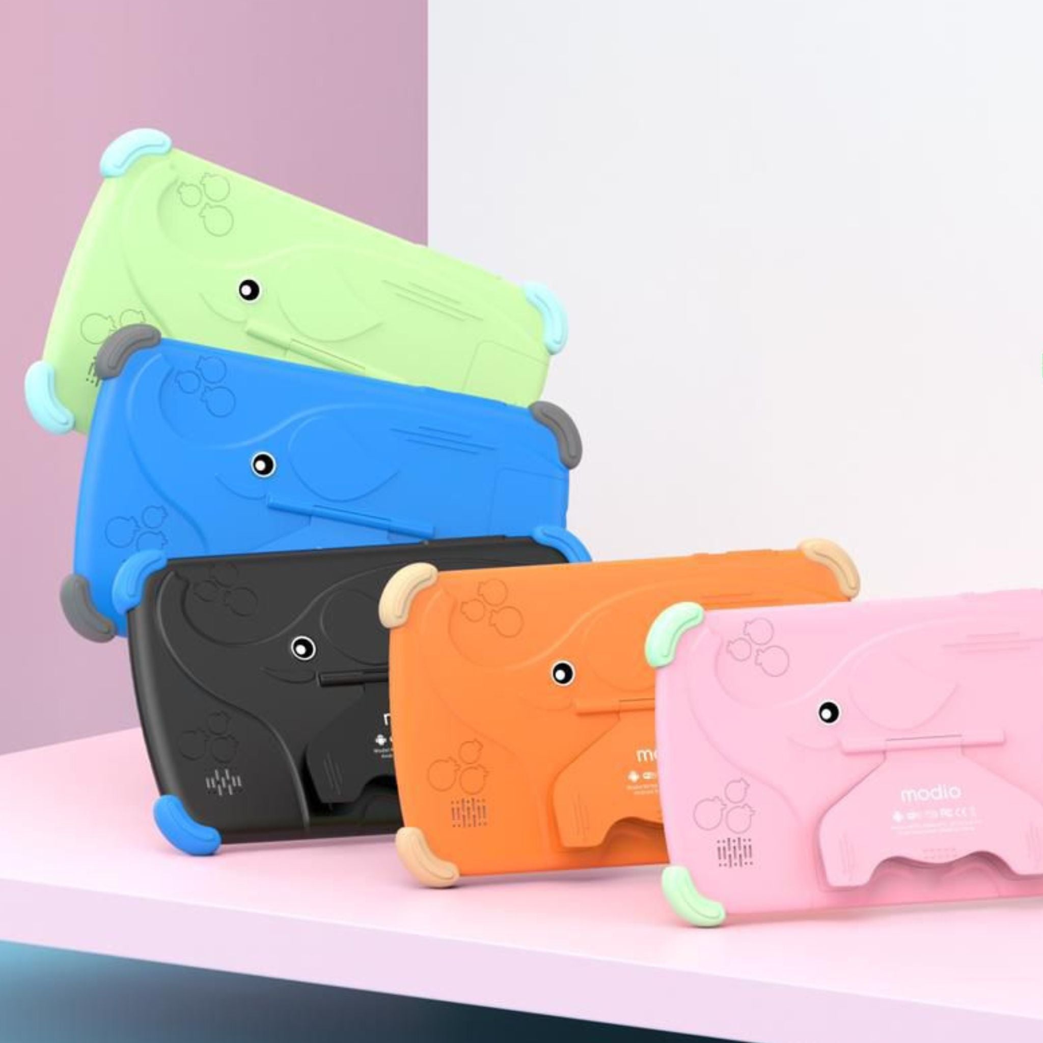 Colorful electronic devices shaped like cartoon characters on a pink surface with a light purple background.