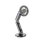 A foldable magnetic car mount in black color with a strong magnet and flexible design for holding smartphones securely.