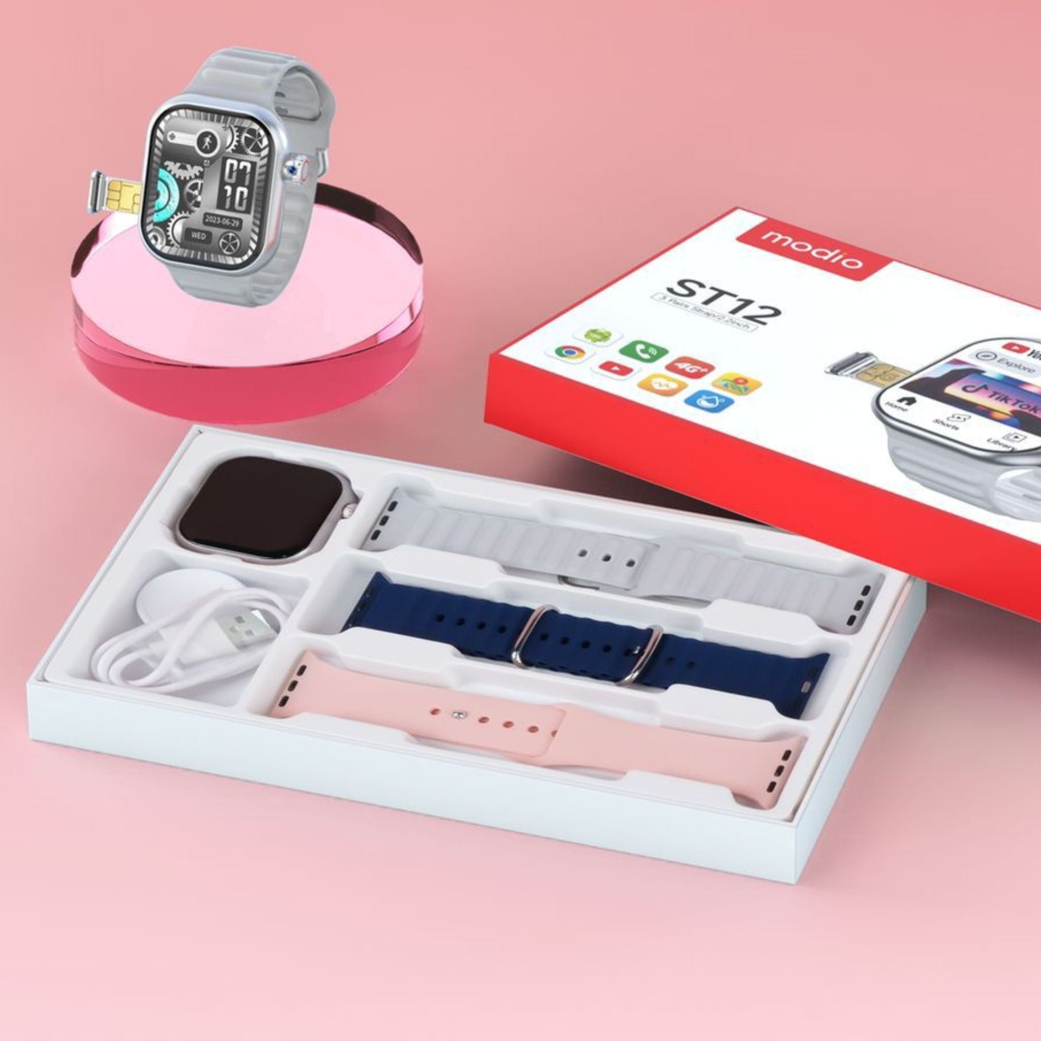 Modio ST12 smartwatch in silver color with 2.2 inch screen, displayed alongside its packaging and multiple straps in a box.