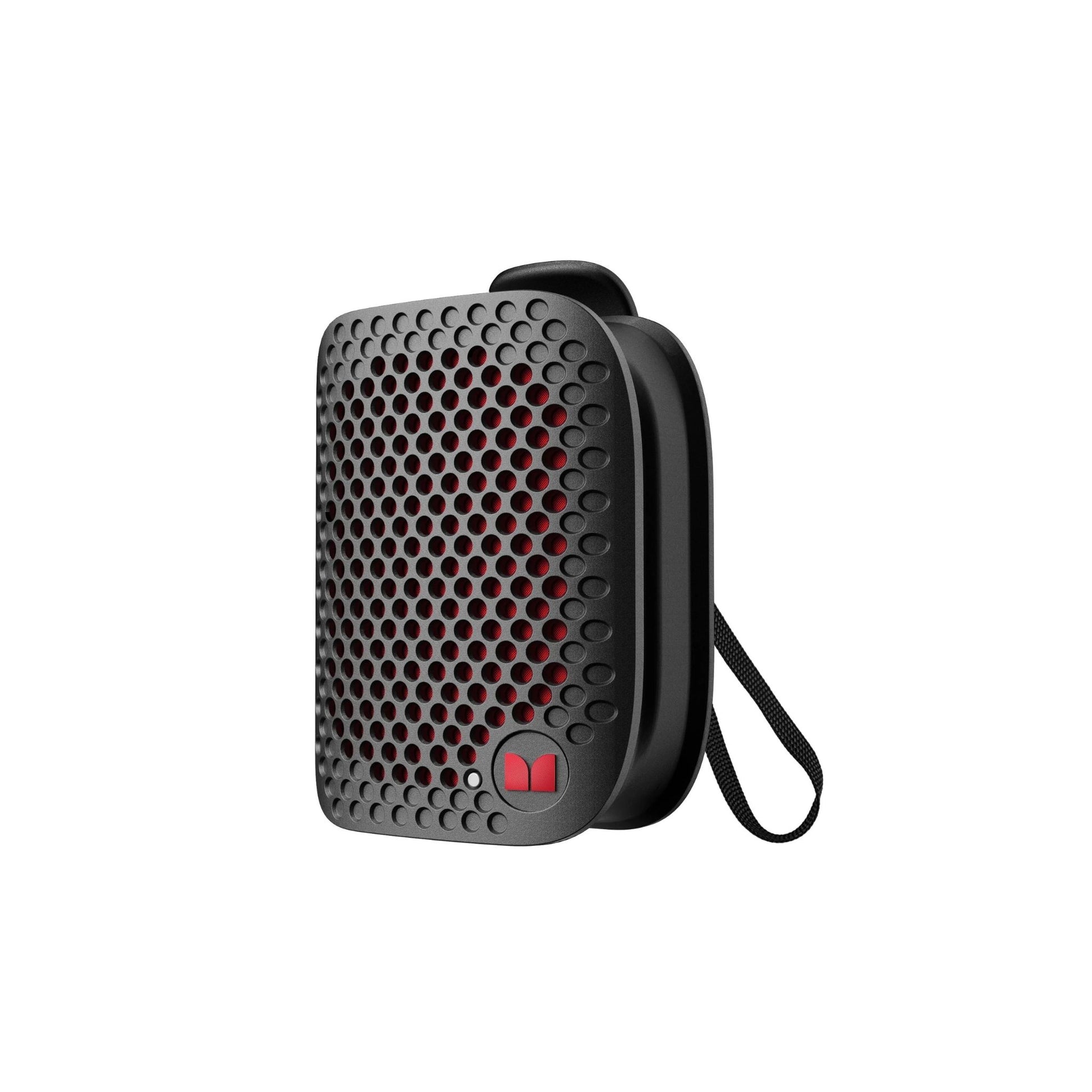 A portable black Bluetooth speaker with a clip-on feature and an IPX7 waterproof design, depicted against a white background.