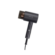 A gray Green Lion foldable hair dryer with a W-shaped heater, seen from the side with the power cord visible.