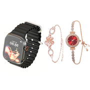 A collection of jewelry including a black band smart watch with a silver clasp, and two rose gold tone bracelets with decorative elements.