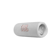 A white JBL Flip 6 portable IP67 waterproof speaker laying horizontally with the JBL logo displayed on the front.