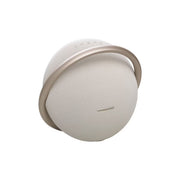Harman Kardon Onyx Studio 8 Portable Wireless Speaker in rose gold color with a round shape and a metallic handle.