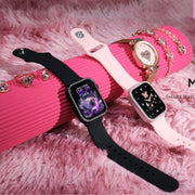 The image shows two Modio MW17 Mini Smartwatches, one with a black band and the other with a pink band, displayed alongside diamond jewelry on a pink fluffy surface. Both watches have a diamond encrusted dial.