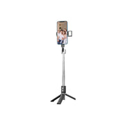 An adjustable black selfie stick with a remote control and a four-legged base, designed to be compatible with various smartphone sizes.
