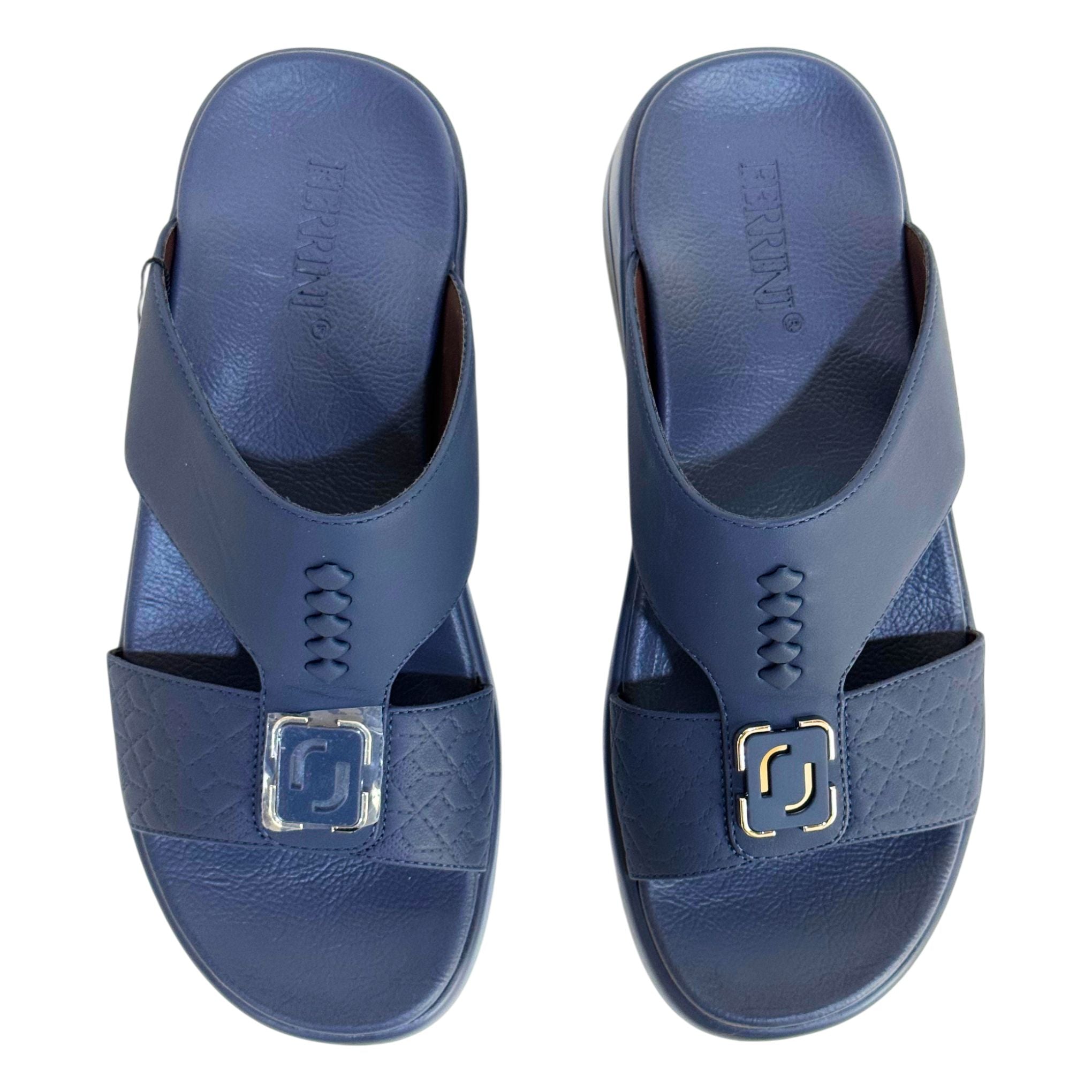 Pair of blue sandals with a gold buckle on a white background