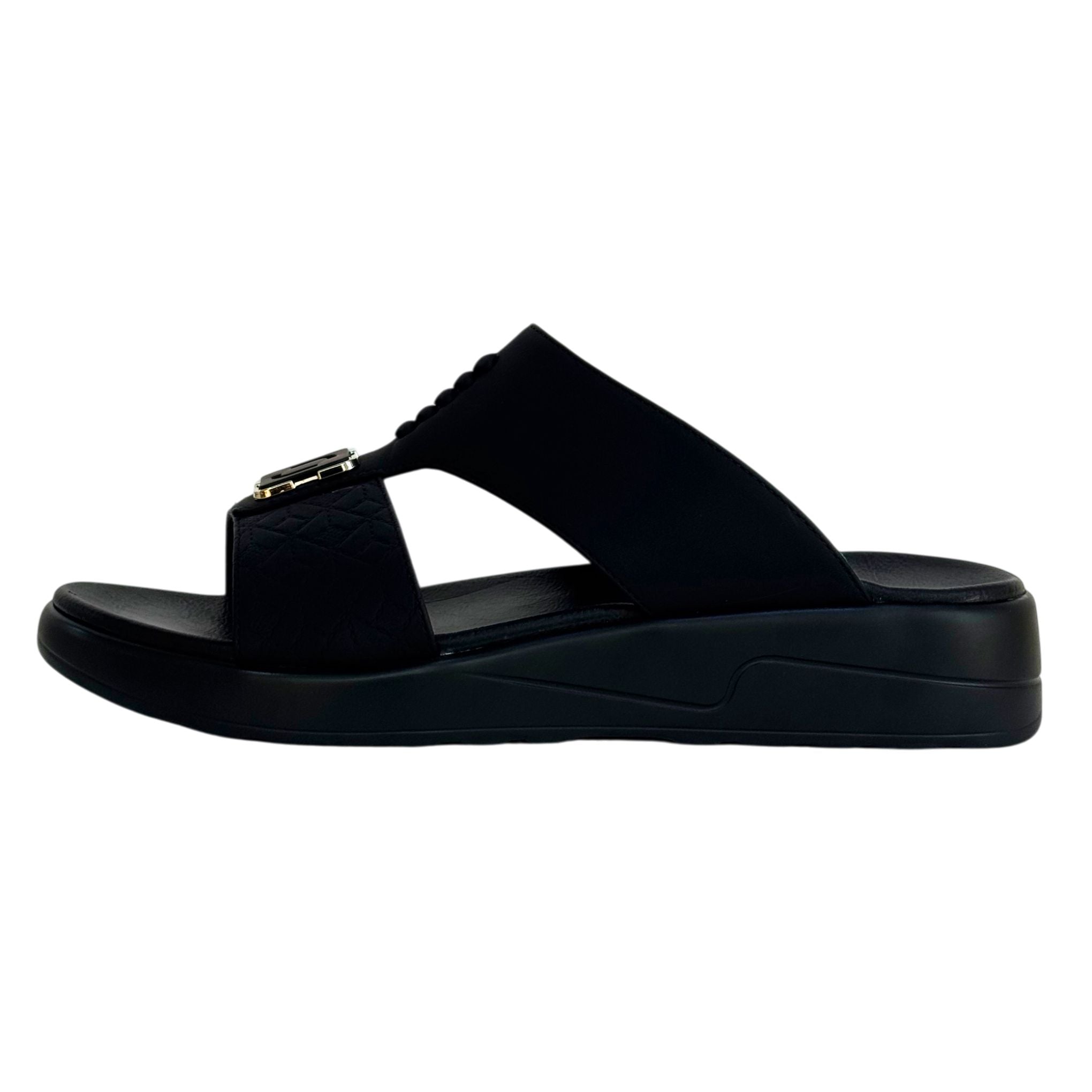 Black sandal with a platform sole on a white background